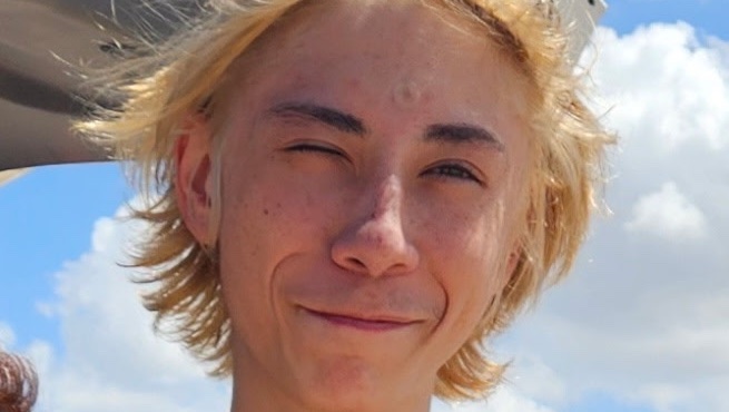 Close-up of Logan winking on a sunny day